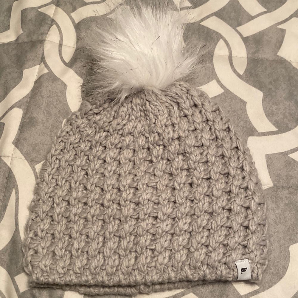 Knit hat with white pom pom